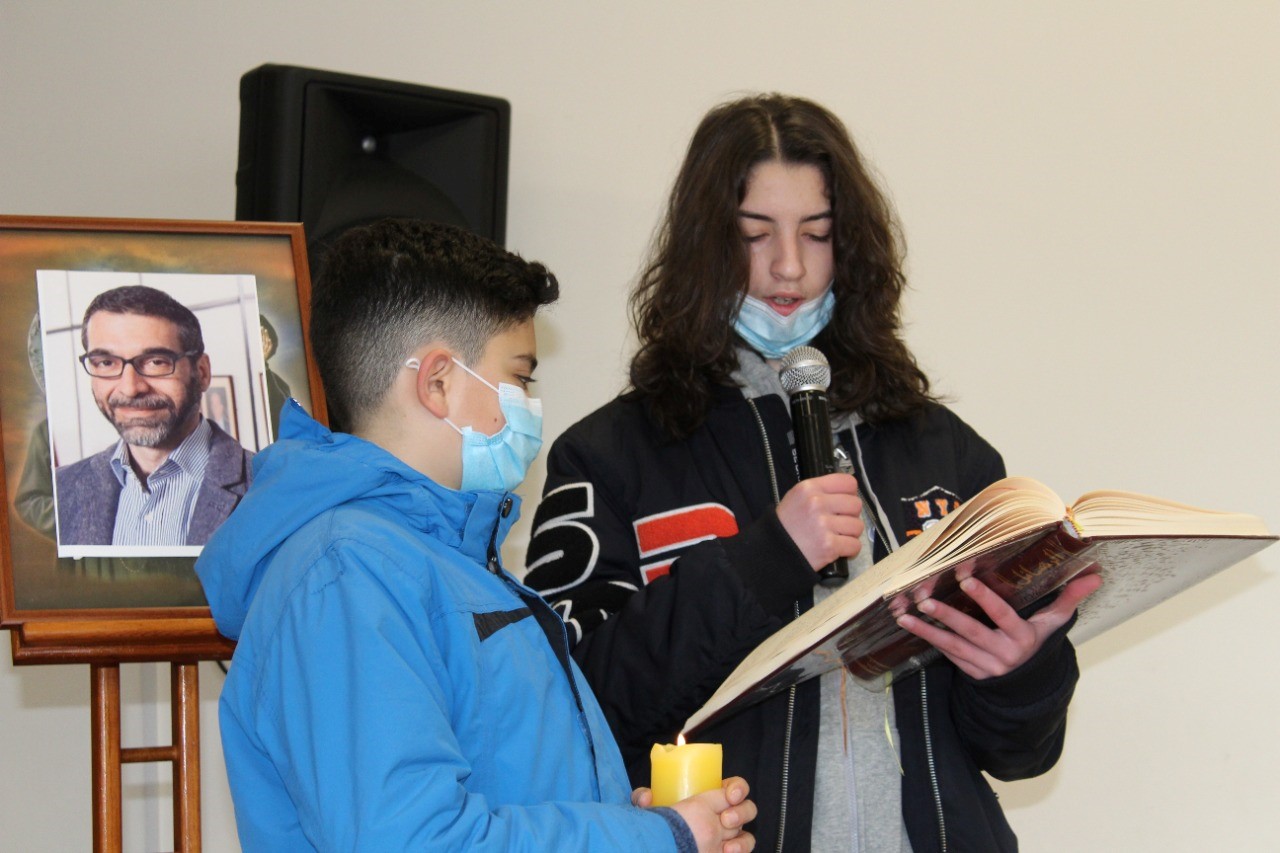 Students Praying in Memory of Hubert Fattal